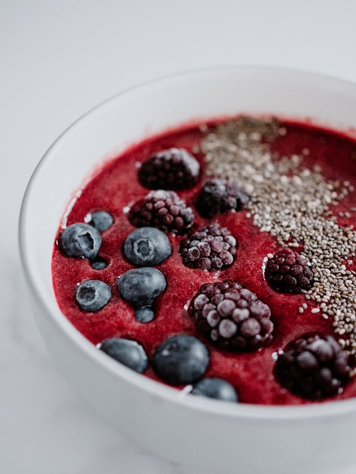 Fresh berry smoothie bowl with chia seeds, a healthy and colorful breakfast option.
